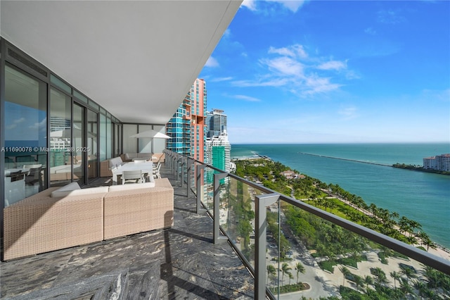 balcony with a water view and an outdoor living space