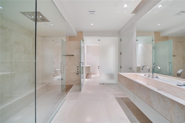 bathroom with vanity, toilet, tile patterned floors, and walk in shower