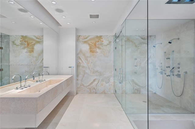 bathroom featuring vanity, tile walls, and walk in shower