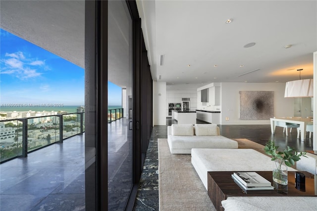 living room featuring expansive windows and a water view