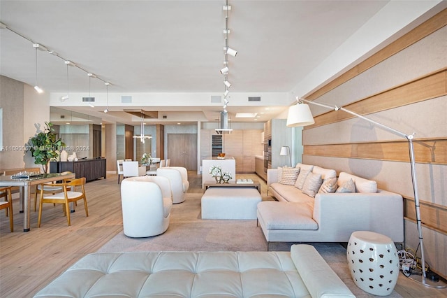 living room with wood-type flooring and track lighting