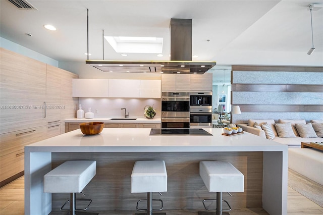 kitchen with black electric stovetop, decorative backsplash, a large island, a kitchen bar, and stainless steel double oven