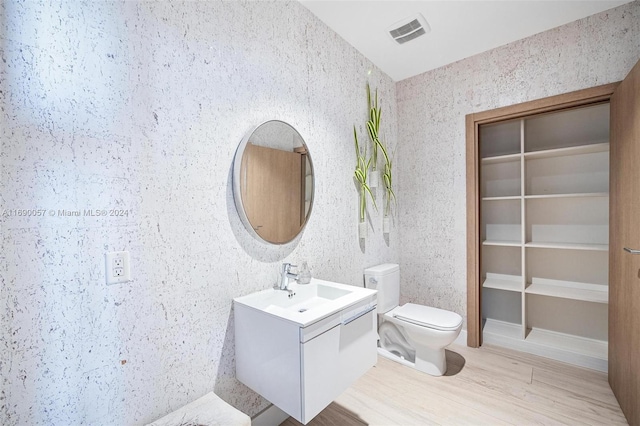 bathroom featuring hardwood / wood-style floors, vanity, and toilet