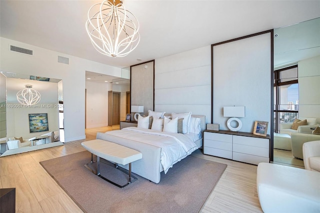 bedroom featuring a chandelier and wood-type flooring