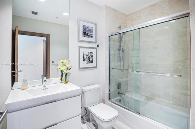 full bathroom with tile patterned floors, vanity, toilet, and enclosed tub / shower combo