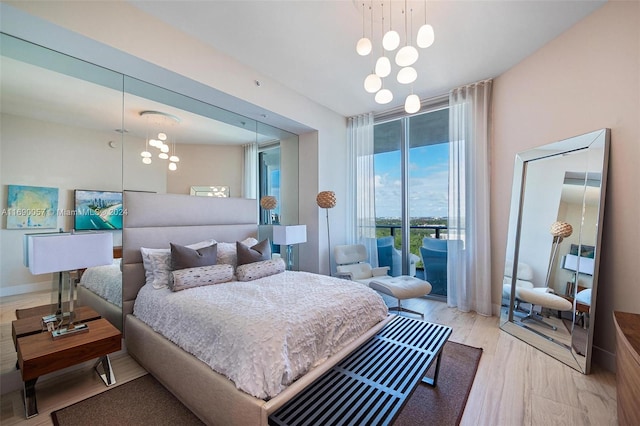 bedroom featuring light hardwood / wood-style floors and access to outside