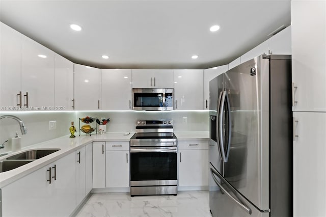 kitchen with white cabinetry, sink, and appliances with stainless steel finishes