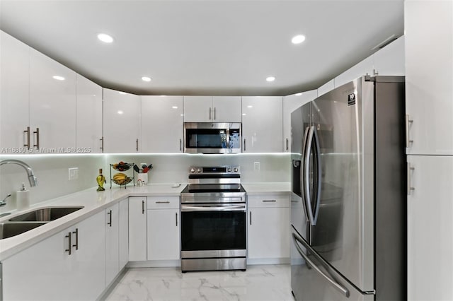 2500 Parkview Dr Unit 2303, Hallandale Beach, FL 33009 - kitchen with a sink, stainless steel appliances, white cabinets, light countertops, and marble finish floor