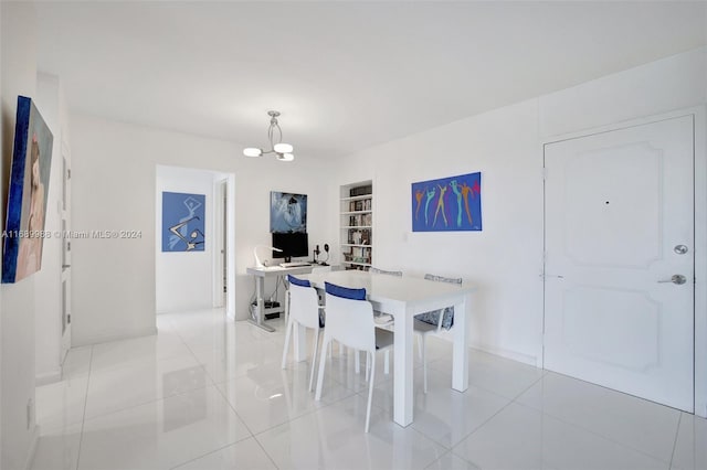 tiled dining space featuring a chandelier