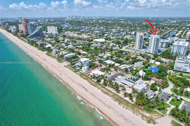 drone / aerial view with a beach view and a water view