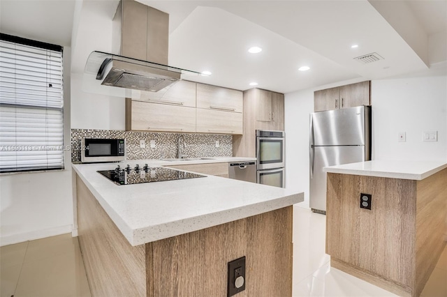 kitchen with tasteful backsplash, ventilation hood, appliances with stainless steel finishes, and a kitchen island