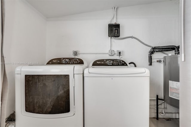 laundry room featuring water heater and independent washer and dryer