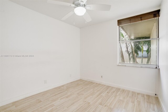 spare room with light wood-type flooring and ceiling fan