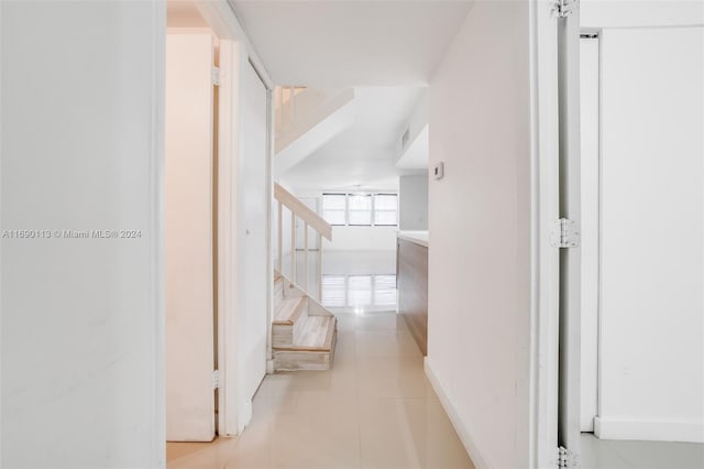 corridor featuring light tile patterned floors