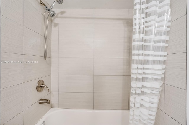 bathroom featuring shower / bathtub combination with curtain