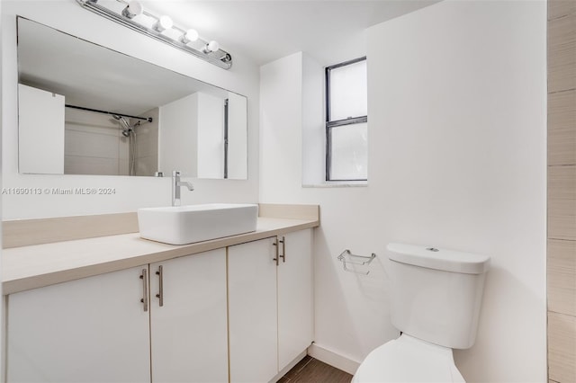 bathroom with hardwood / wood-style floors, vanity, and toilet