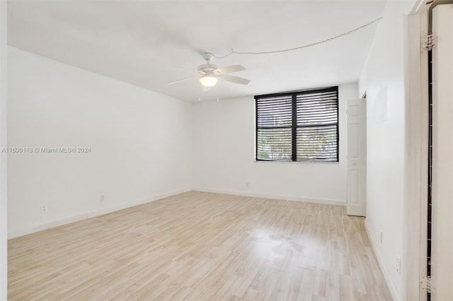 spare room with light wood-type flooring and ceiling fan