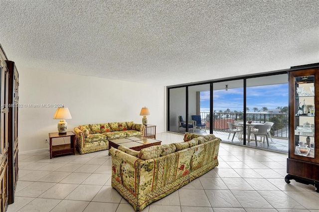 tiled living room with expansive windows and a textured ceiling