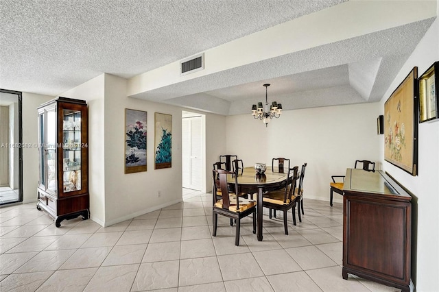 dining room featuring a chandelier, a textured ceiling, and light tile patterned floors