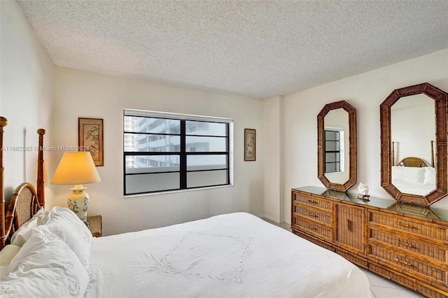 tiled bedroom with a textured ceiling