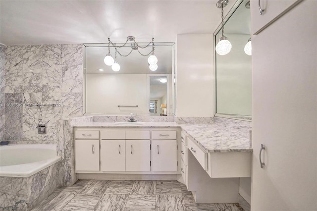 bathroom with vanity and tiled tub