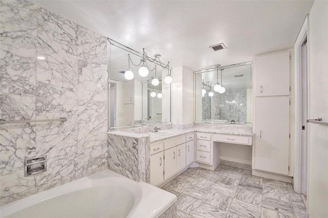 bathroom with a tub to relax in and vanity