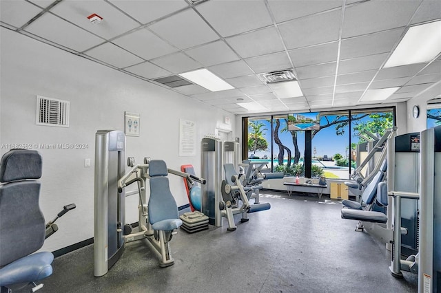 gym with a paneled ceiling