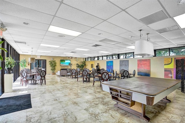 recreation room featuring a drop ceiling