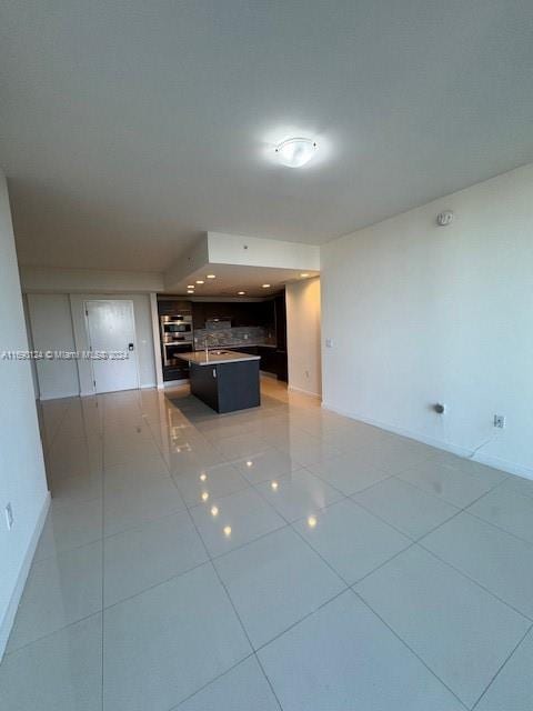 unfurnished living room featuring light tile patterned floors