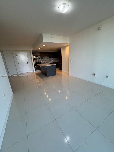 unfurnished living room featuring tile patterned floors