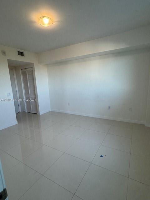 empty room with light tile patterned floors