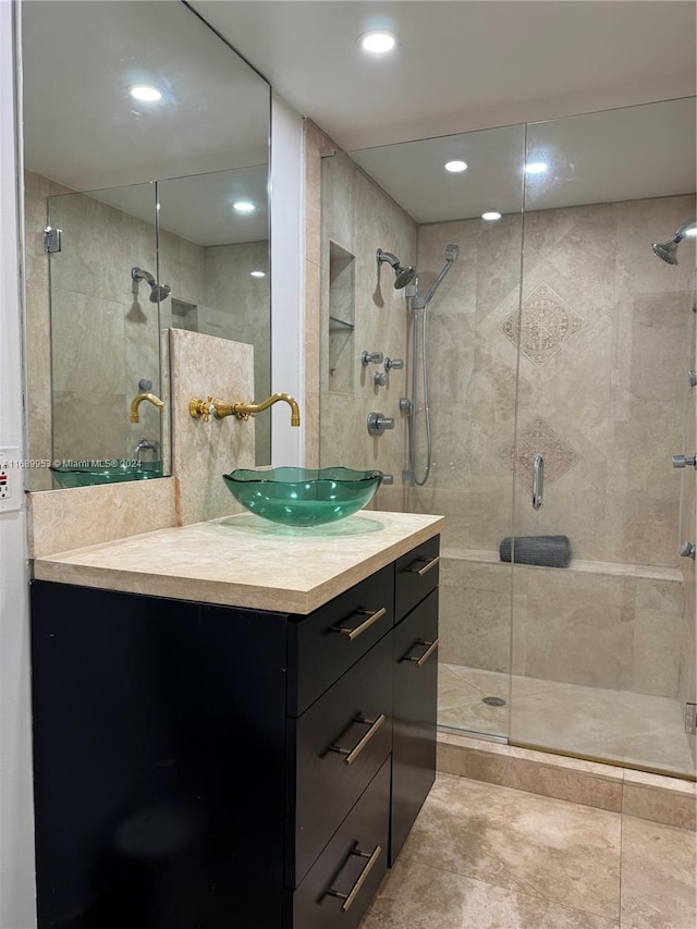 bathroom with walk in shower and vanity