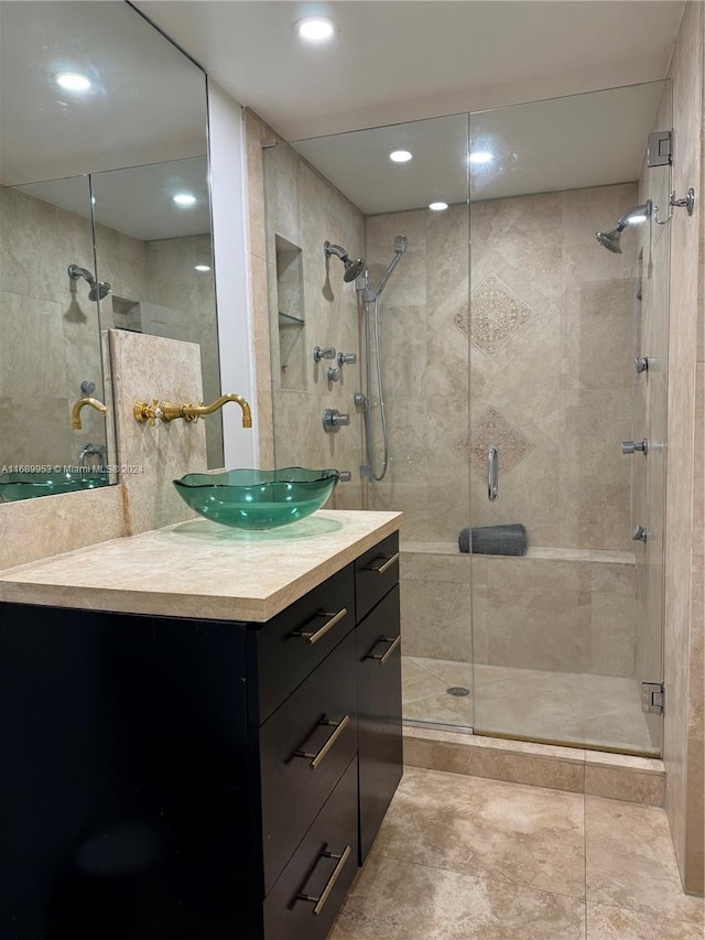 bathroom featuring vanity and a shower with door