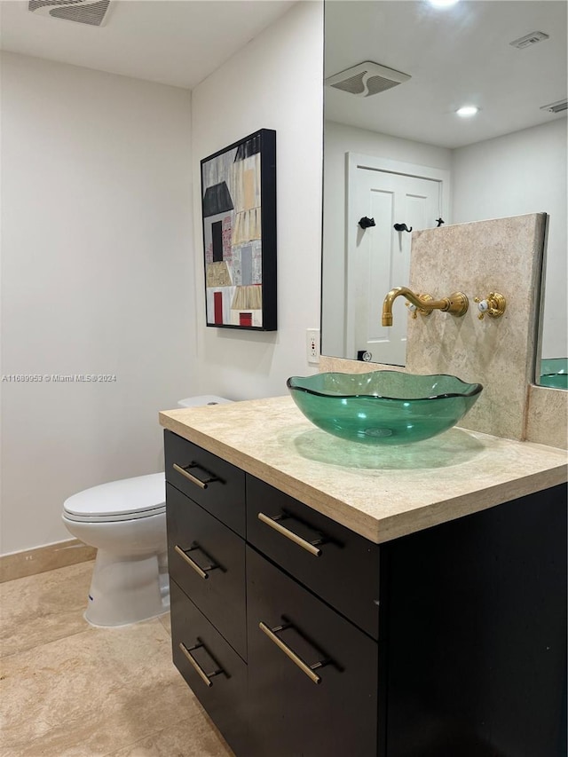 bathroom featuring toilet and vanity