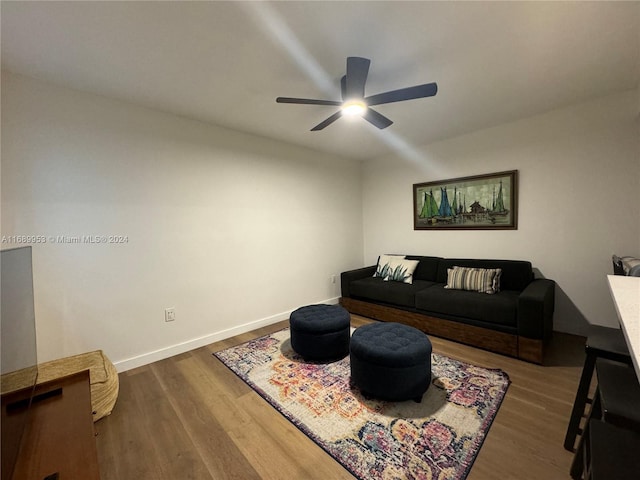 living room featuring dark hardwood / wood-style flooring and ceiling fan