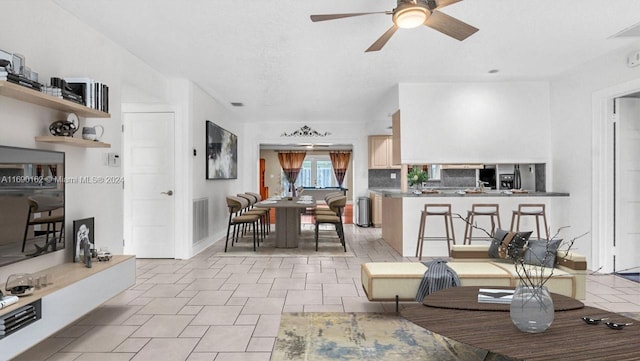 interior space with ceiling fan