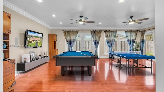 rec room with wood-type flooring, ornamental molding, and a wealth of natural light