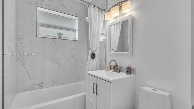 full bathroom with vanity, shower / tub combo, and toilet