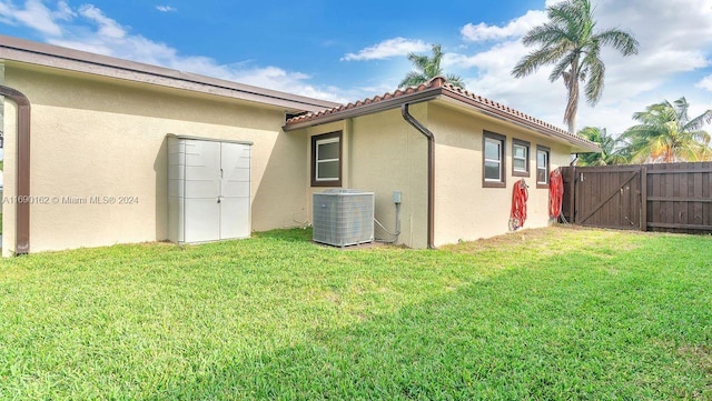 exterior space featuring a yard and central AC