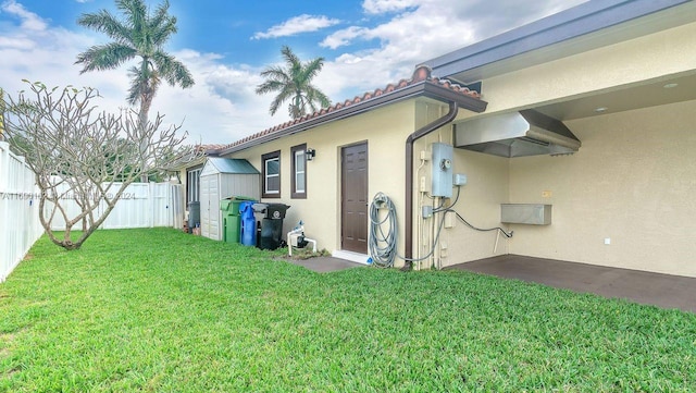 exterior space featuring a lawn and a shed