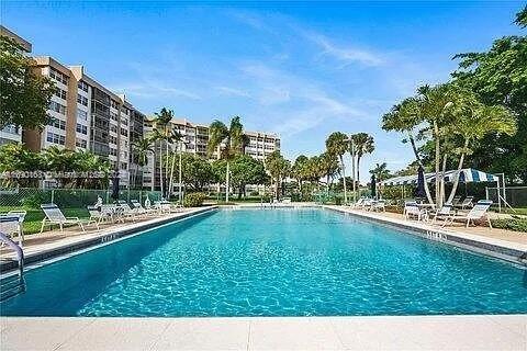 1100 Saint Charles Pl Unit 203, Pembroke Pines, FL 33026 - community pool with a patio area and fence