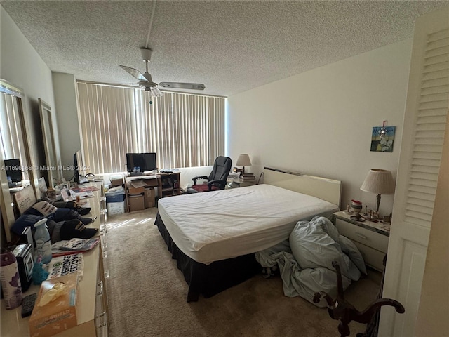 carpeted bedroom with a textured ceiling and ceiling fan