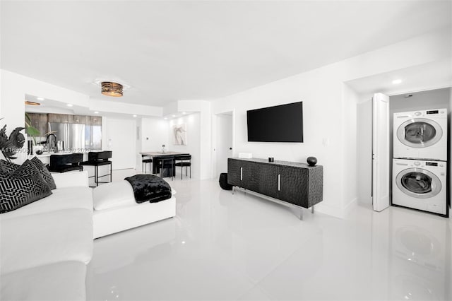 living area featuring stacked washer / drying machine