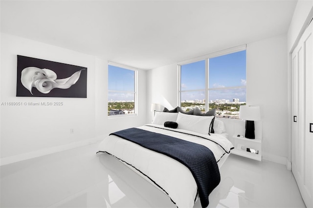 bedroom featuring a city view and baseboards