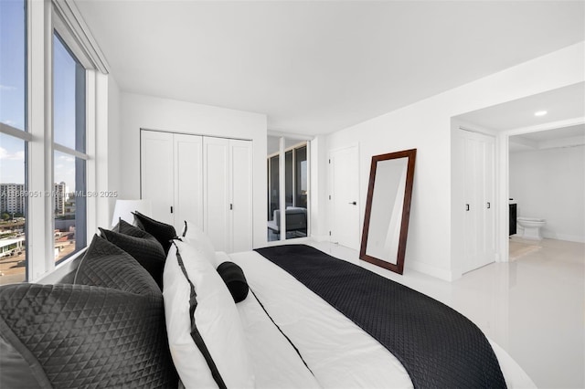 bedroom featuring baseboards and a closet