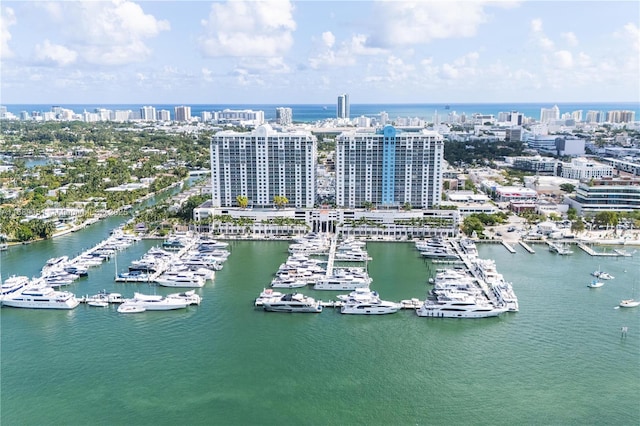 birds eye view of property with a water view and a city view