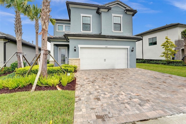 view of front property featuring a garage and a front yard