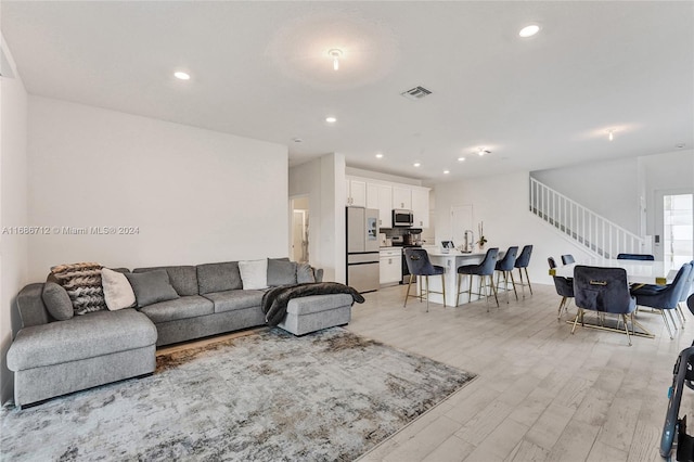 living room with light hardwood / wood-style flooring