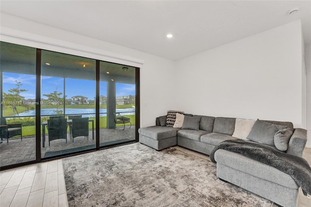 living room with wood-type flooring and a water view