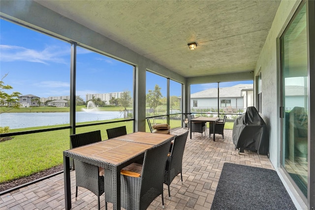 sunroom / solarium with a water view